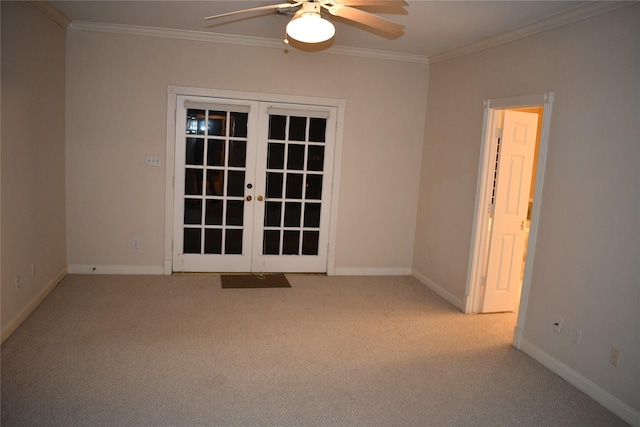 carpeted spare room with ceiling fan, ornamental molding, and french doors