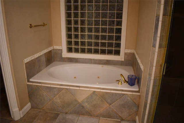 bathroom featuring a relaxing tiled tub and tile patterned floors