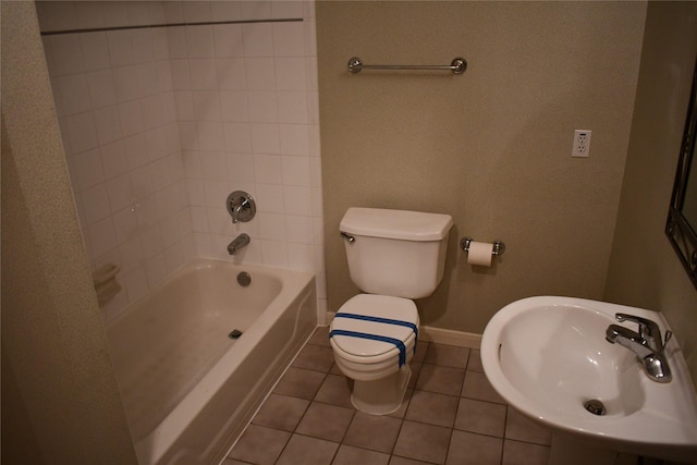 full bathroom featuring tile patterned flooring, toilet, sink, and tiled shower / bath