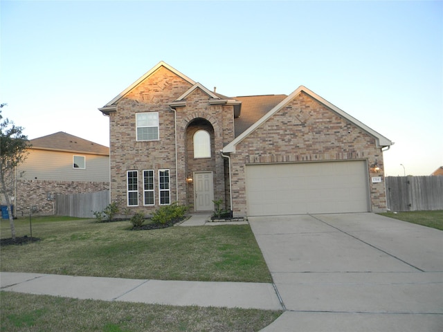 view of front of home with a front yard and a garage