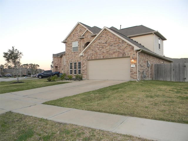 view of front of home with a lawn and a garage