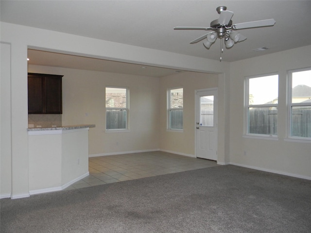 unfurnished living room with light carpet and ceiling fan