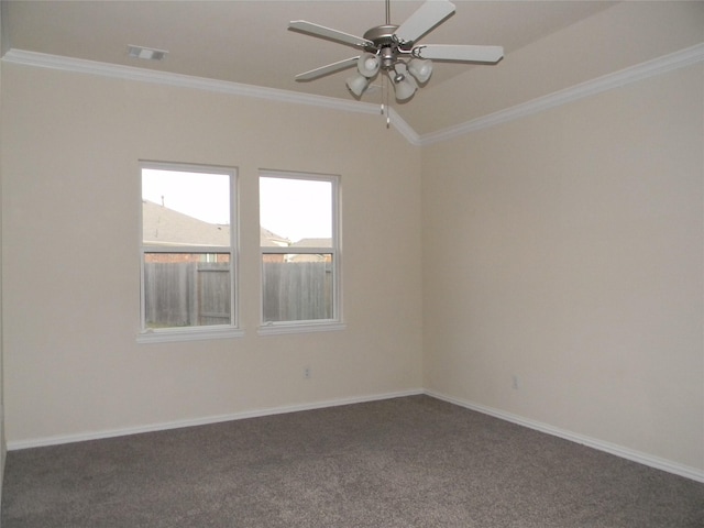 empty room featuring dark colored carpet, ceiling fan, and ornamental molding