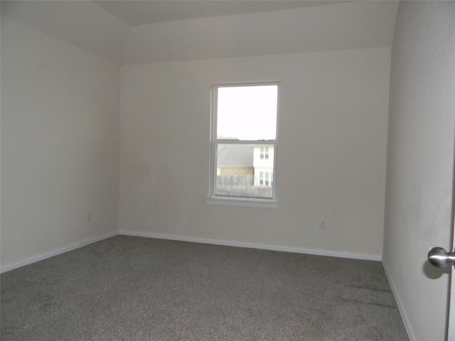 unfurnished room featuring dark colored carpet