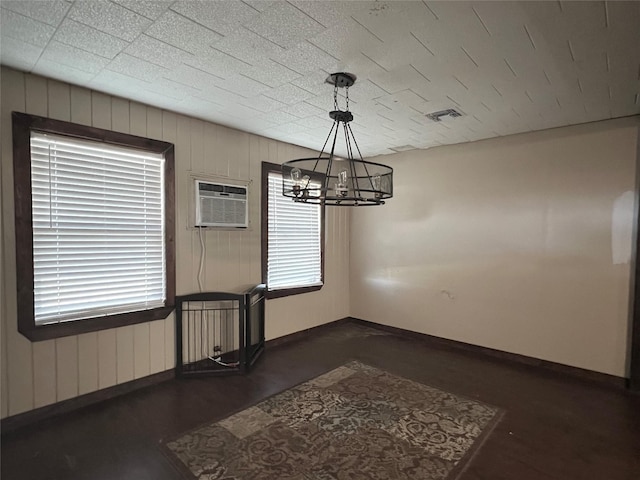 unfurnished dining area with a chandelier and a wall unit AC