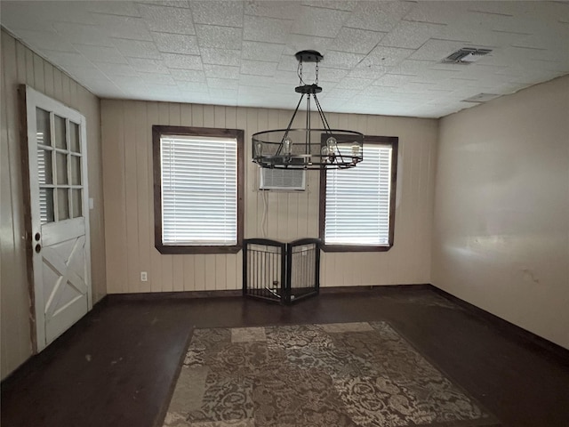 unfurnished dining area with an inviting chandelier and plenty of natural light