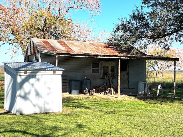 rear view of property featuring a yard