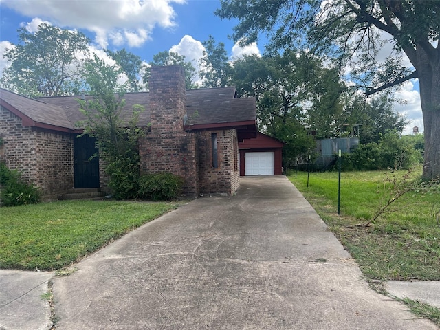 view of front of house with a garage and a front yard