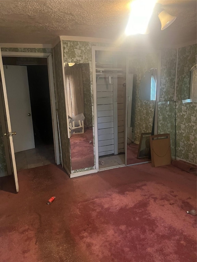 unfurnished bedroom featuring carpet floors and a textured ceiling