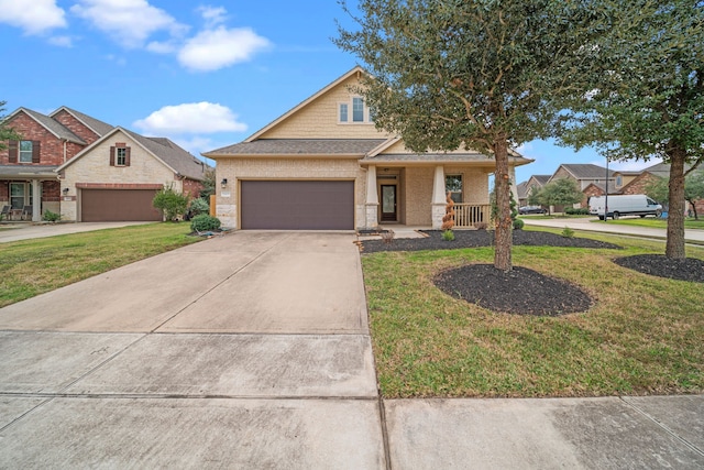 view of front of house featuring a porch, a garage, and a front lawn