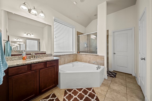 bathroom featuring lofted ceiling, tile patterned floors, plus walk in shower, and vanity