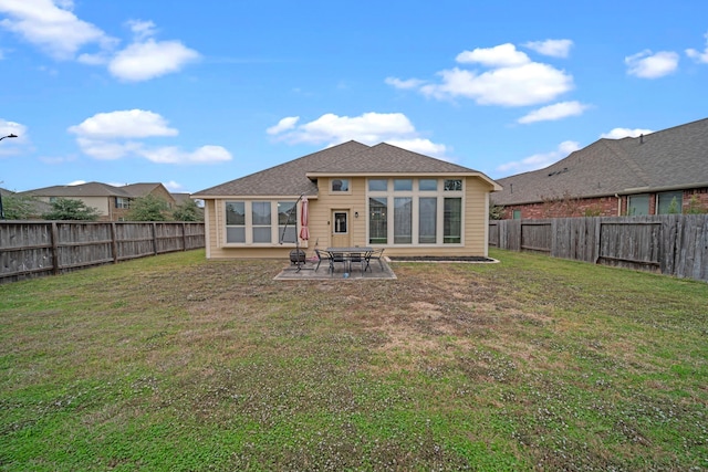 rear view of house with a yard and a patio area