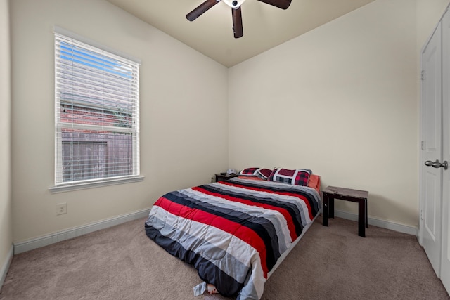 carpeted bedroom with vaulted ceiling and ceiling fan