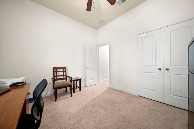 carpeted office space with high vaulted ceiling and ceiling fan