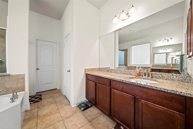 bathroom featuring tile patterned floors, a bathtub, and vanity