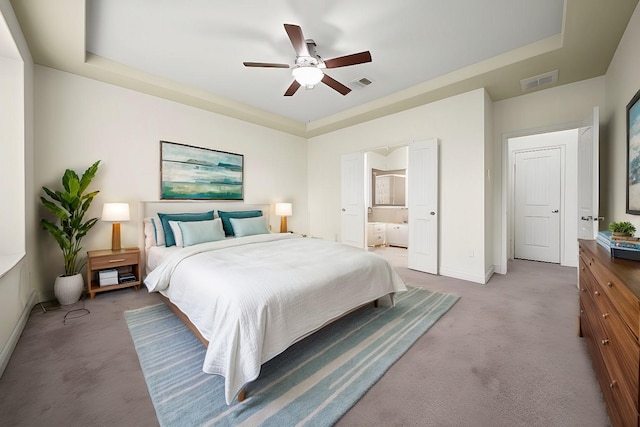 bedroom with a raised ceiling, light carpet, and ceiling fan