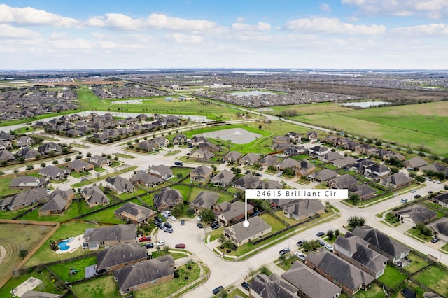 birds eye view of property with a residential view and a water view