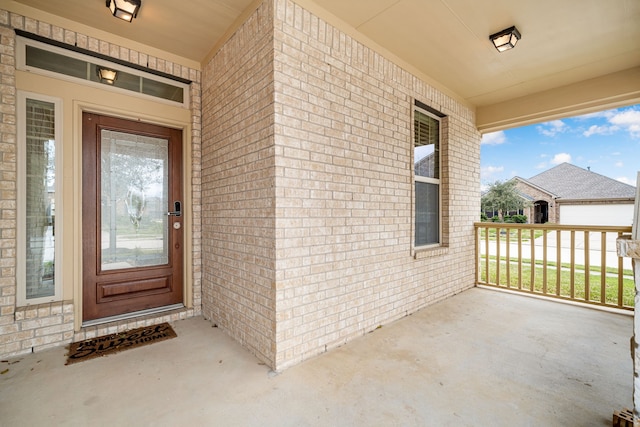 doorway to property featuring brick siding