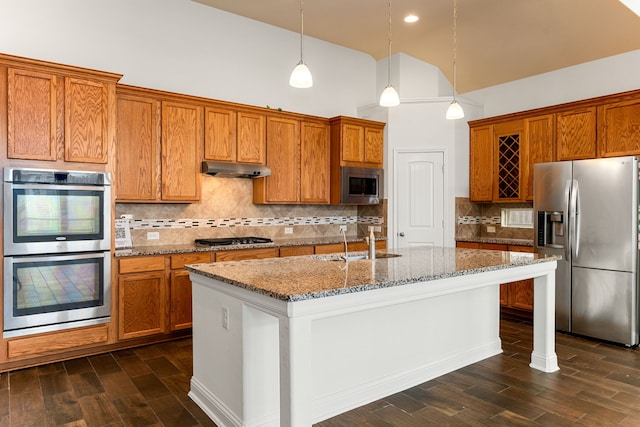 kitchen featuring dark wood-style floors, brown cabinets, appliances with stainless steel finishes, and a sink