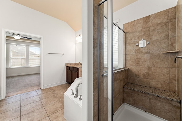 bathroom featuring tile patterned floors, lofted ceiling, vanity, and a shower stall