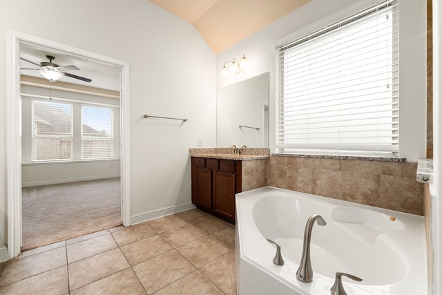 full bathroom featuring vanity, a ceiling fan, lofted ceiling, tile patterned flooring, and a garden tub