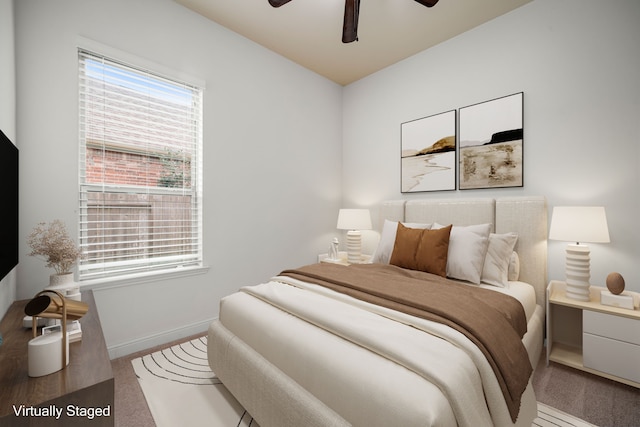 carpeted bedroom with ceiling fan and baseboards