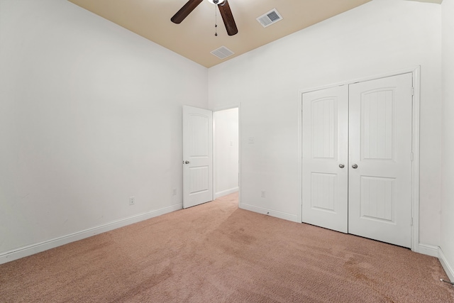 unfurnished bedroom featuring light colored carpet, visible vents, and baseboards