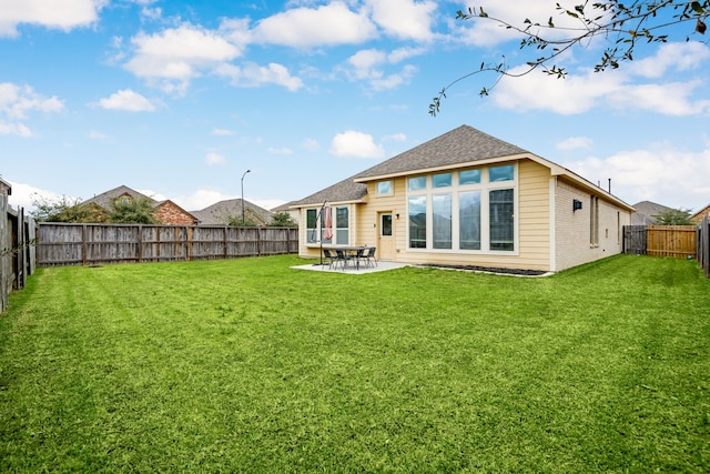 back of property featuring a patio, a fenced backyard, a lawn, and roof with shingles