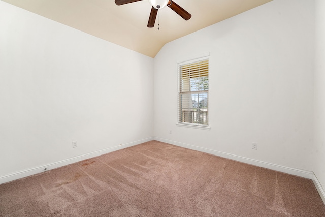 unfurnished room with lofted ceiling, carpet flooring, a ceiling fan, and baseboards