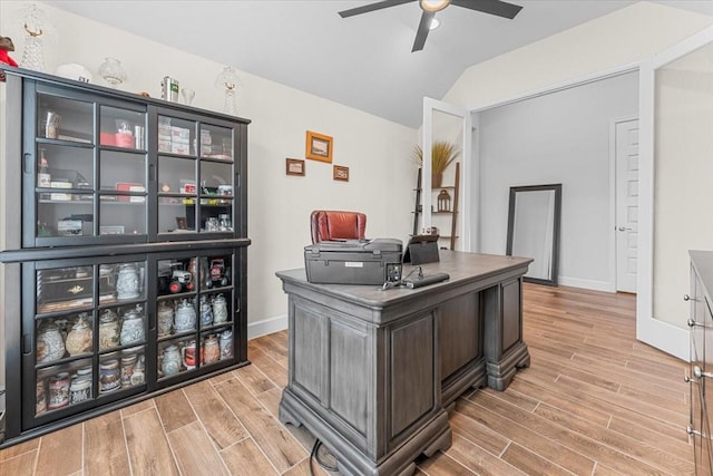 office featuring wood tiled floor, ceiling fan, lofted ceiling, and baseboards