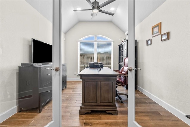 office featuring a ceiling fan, wood tiled floor, lofted ceiling, and baseboards