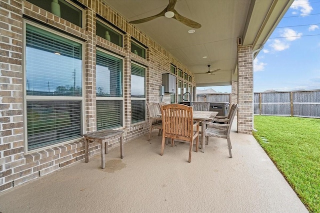 view of patio / terrace with ceiling fan, a fenced backyard, and outdoor dining space