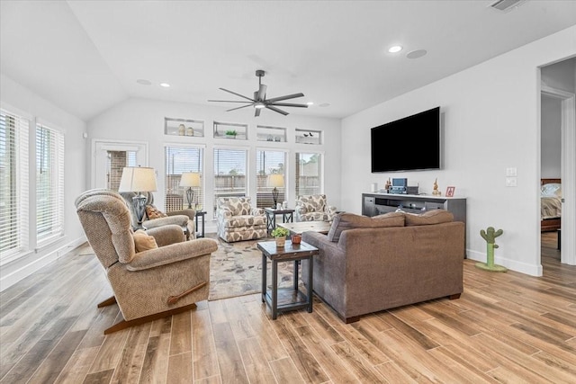 living room featuring lofted ceiling, light wood-style flooring, recessed lighting, a ceiling fan, and baseboards