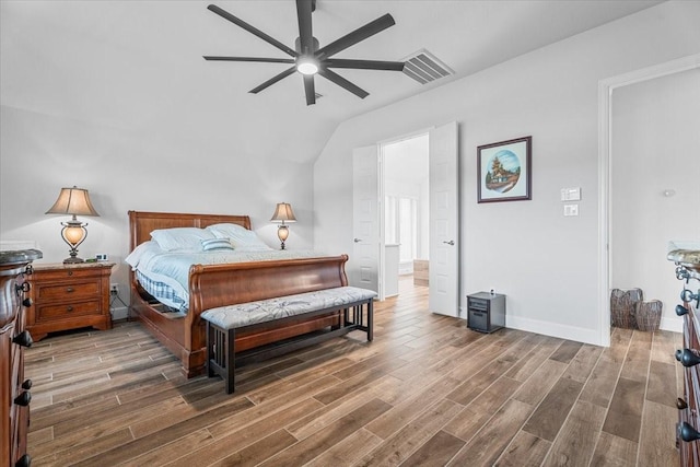 bedroom with dark wood-style floors, visible vents, ceiling fan, and baseboards