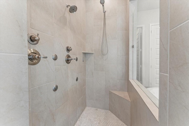 bathroom with tiled shower