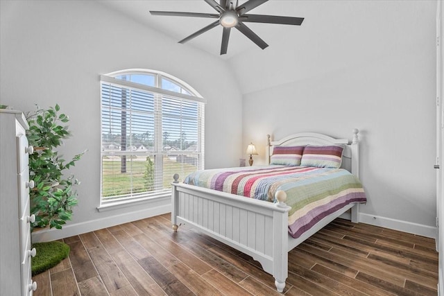 bedroom with lofted ceiling, ceiling fan, baseboards, and dark wood finished floors