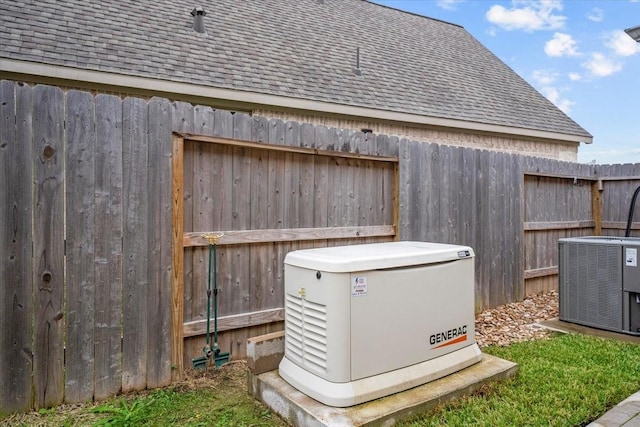 details featuring fence, a power unit, and central AC unit