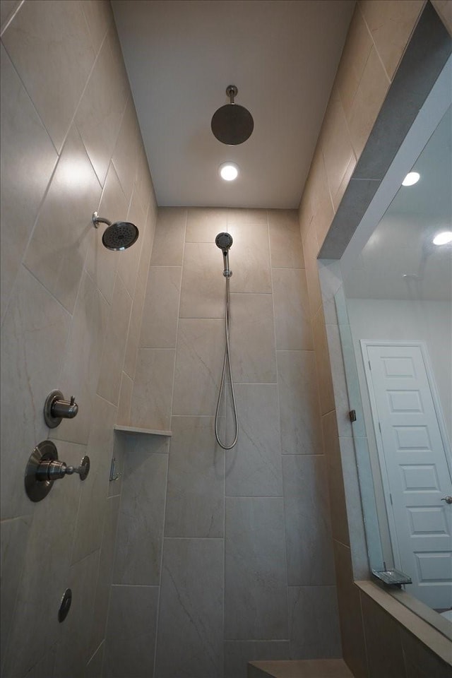 bathroom with tiled shower and recessed lighting