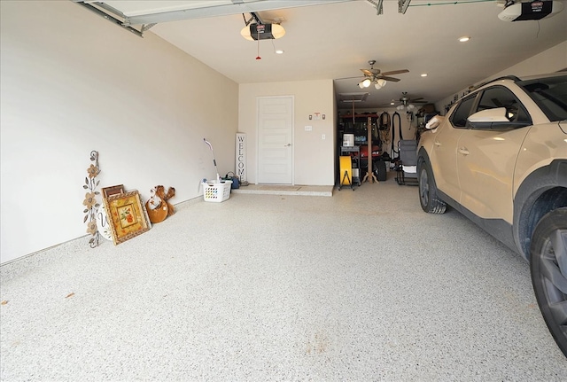 garage with recessed lighting and a garage door opener