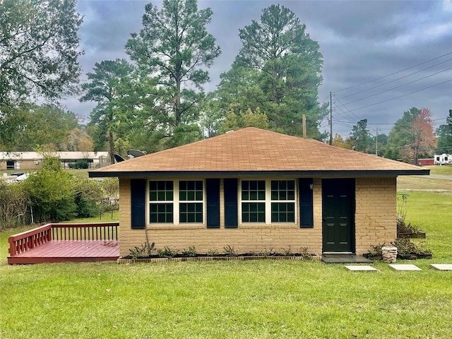 exterior space with a front yard and a deck