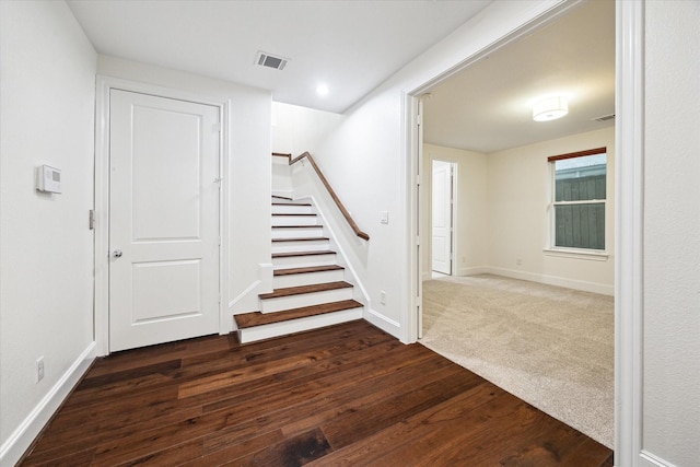 stairs featuring hardwood / wood-style floors