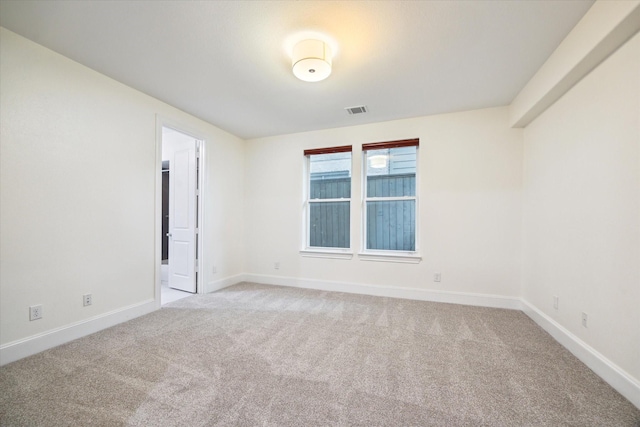 unfurnished room featuring light colored carpet