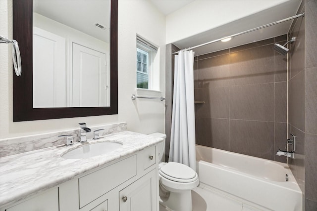 full bathroom with toilet, vanity, and shower / tub combo with curtain