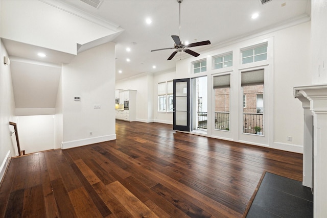 unfurnished living room featuring a towering ceiling, dark hardwood / wood-style floors, ceiling fan, and ornamental molding