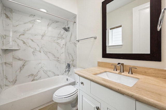 full bathroom featuring tiled shower / bath combo, toilet, and vanity