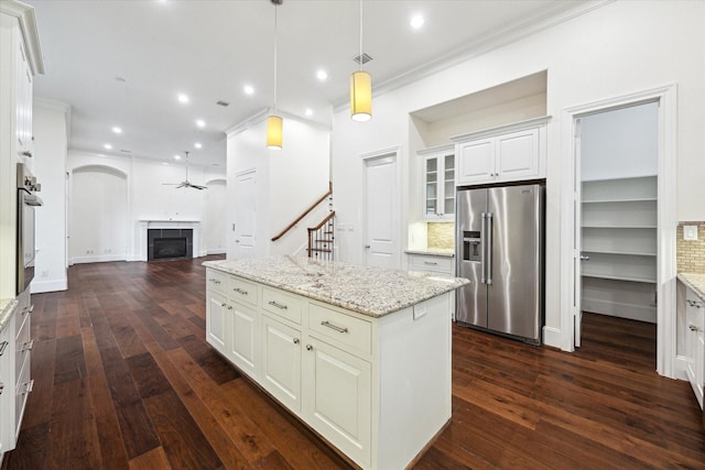 kitchen featuring high end refrigerator, ceiling fan, dark wood-type flooring, and light stone counters