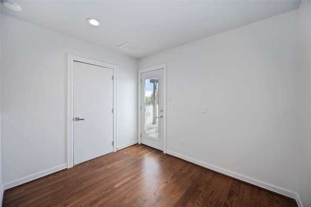 spare room featuring dark hardwood / wood-style floors