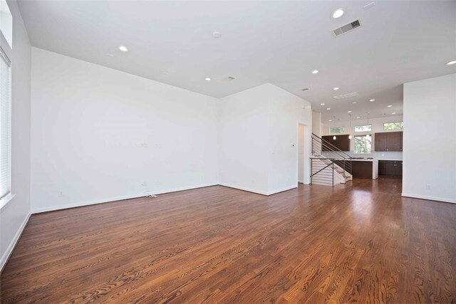 unfurnished living room with dark hardwood / wood-style flooring