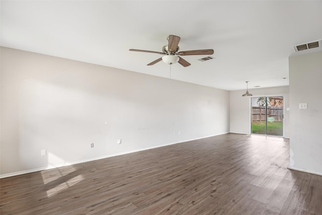 spare room featuring dark hardwood / wood-style flooring and ceiling fan