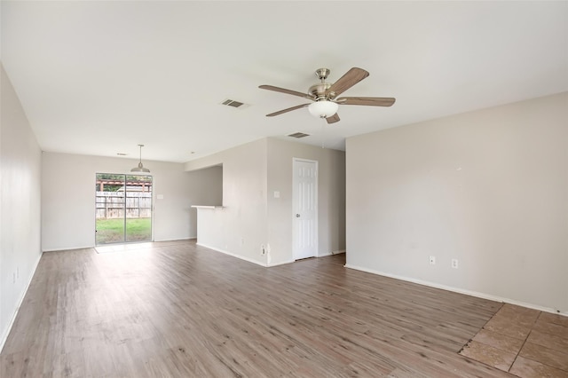 unfurnished room with hardwood / wood-style floors and ceiling fan